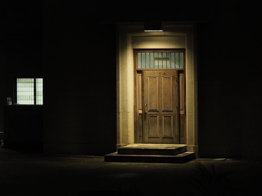A dimly lit wooden doorway captures mystery and intrigue on a quiet Hong Kong night.