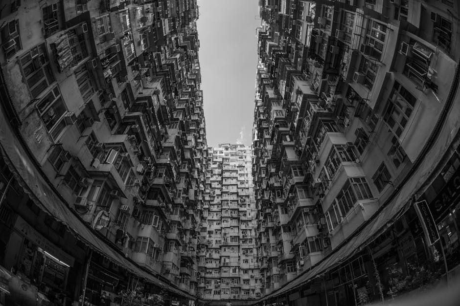 Black and white fisheye perspective of dense residential buildings in Hong Kong.