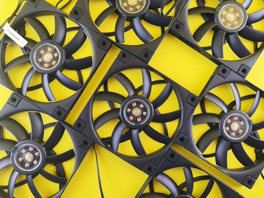 Black computer cooling fans organized in a grid on a vibrant yellow background.
