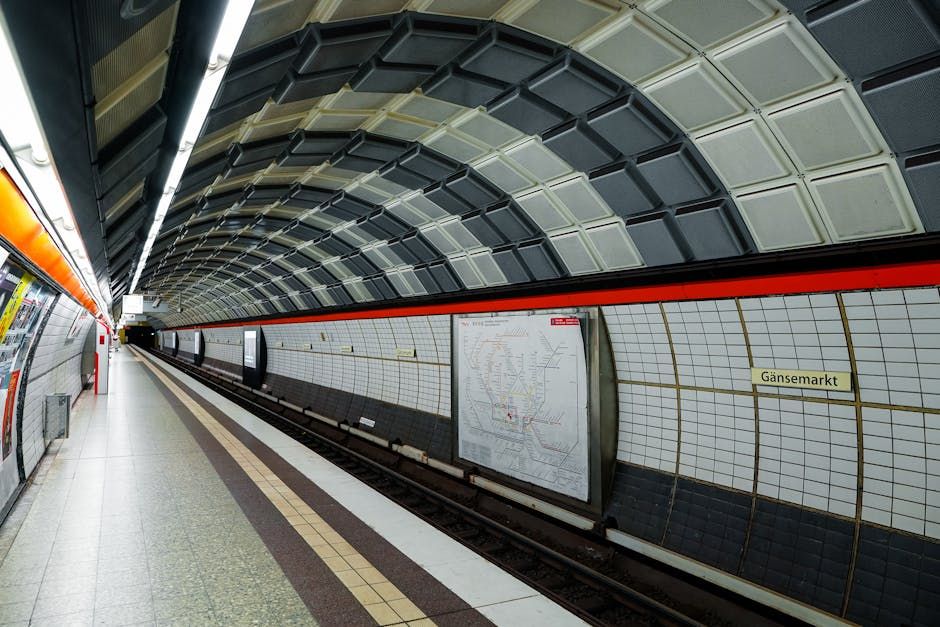 Empty metro station in Hamburg showcasing modern infrastructure and architectural design.