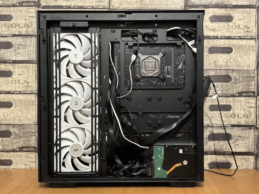 Interior view of an open computer case featuring cooling fans and wiring.